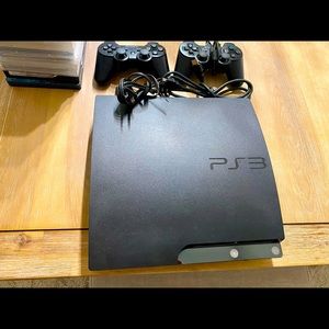 PS3 slim 120GB w/ (2) controllers and cords. Plus 15 games